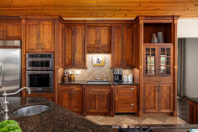 kitchen featuring appliances with stainless steel finishes, light tile patterned floors, and sink