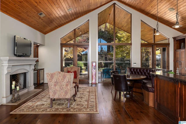 living room featuring wood ceiling, dark wood-type flooring, a wealth of natural light, and vaulted ceiling