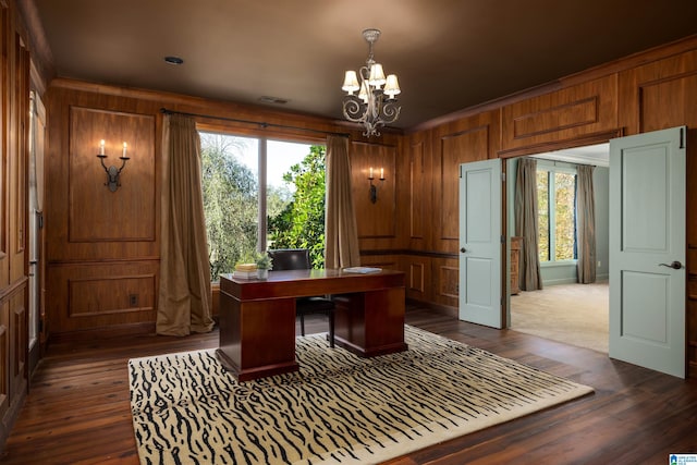 office featuring wooden walls, crown molding, dark hardwood / wood-style floors, and an inviting chandelier