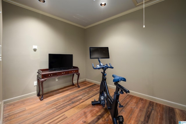 exercise area featuring hardwood / wood-style flooring and crown molding