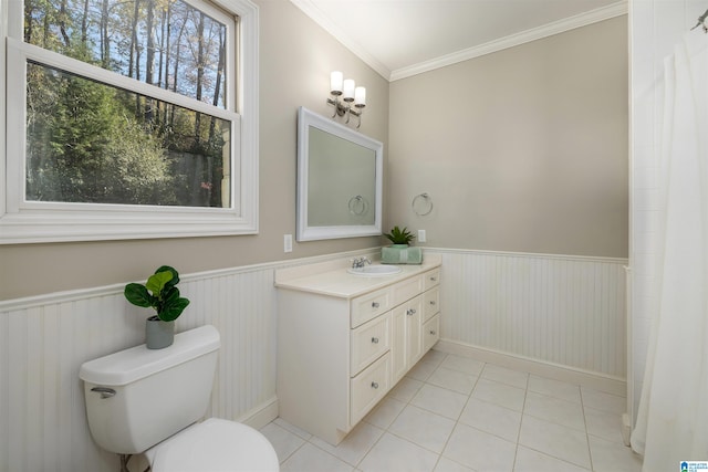 bathroom with toilet, vanity, tile patterned floors, and ornamental molding