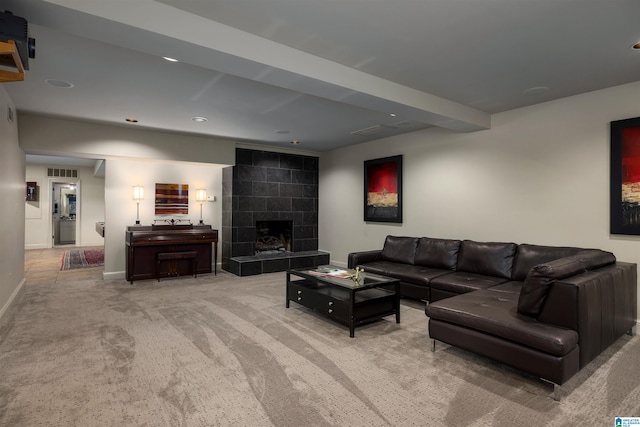 carpeted living room with a tiled fireplace