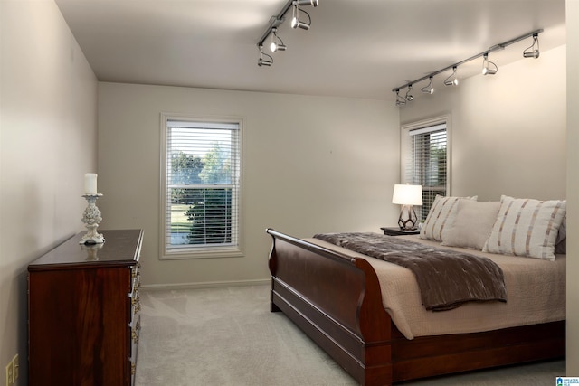 bedroom featuring light carpet