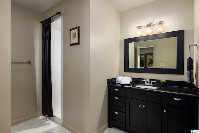 bathroom featuring tile patterned flooring and vanity