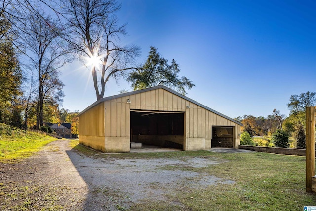 view of outbuilding with a garage and a yard