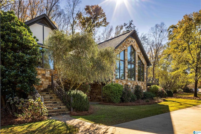 view of front of property featuring a front yard and a sunroom