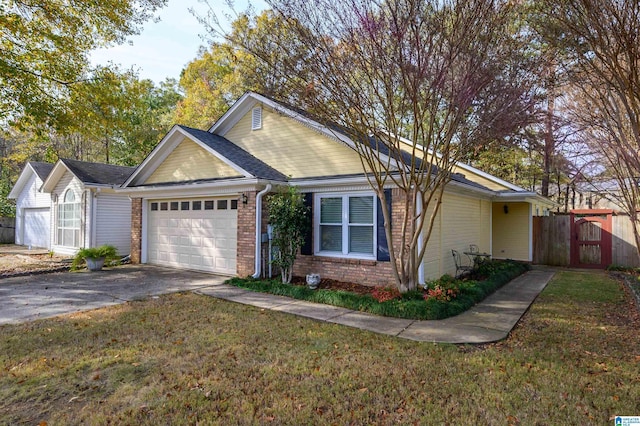 ranch-style home featuring a front lawn and a garage