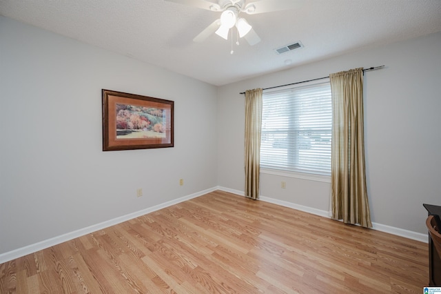 unfurnished room with ceiling fan, a textured ceiling, and light hardwood / wood-style flooring