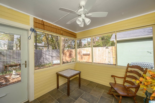 sunroom featuring ceiling fan