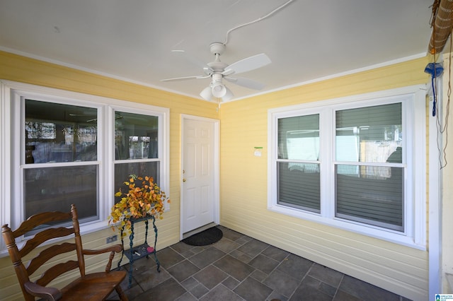 entrance to property with ceiling fan