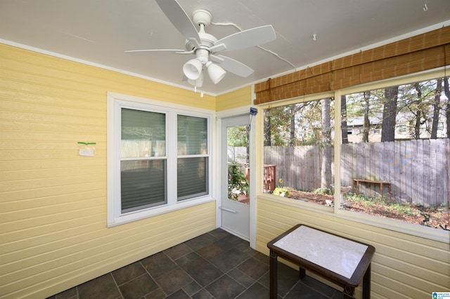 sunroom / solarium featuring ceiling fan