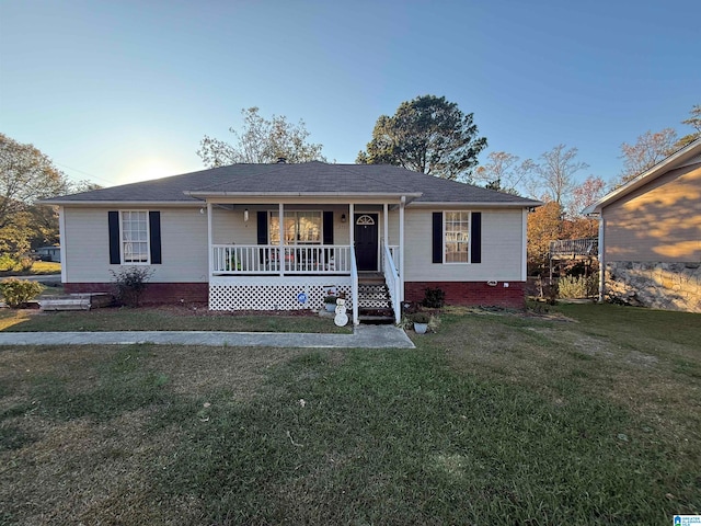 ranch-style house with covered porch and a front yard