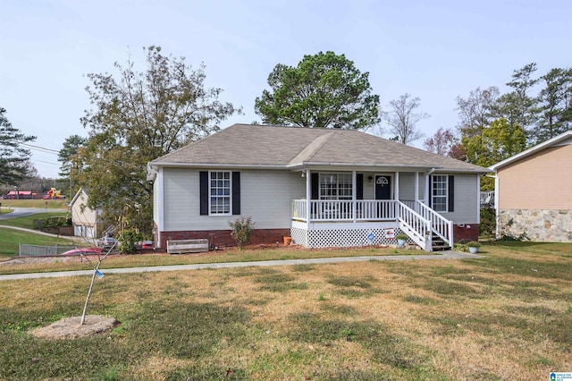 ranch-style home with covered porch and a front yard