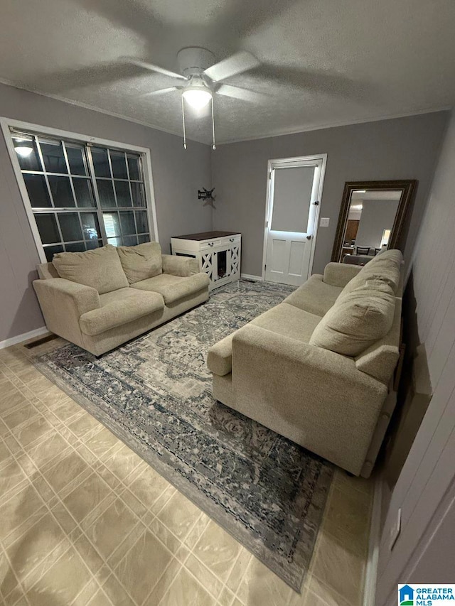 living room with ceiling fan and a textured ceiling