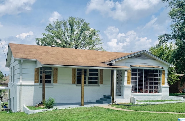 16 9th Ter, Birmingham, AL 35211 - view of front of house with brick siding, a shingled roof, and a front lawn