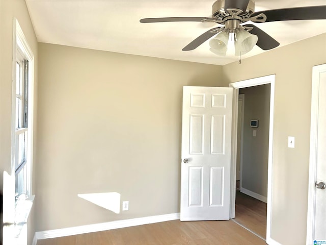 unfurnished bedroom with ceiling fan and light hardwood / wood-style flooring