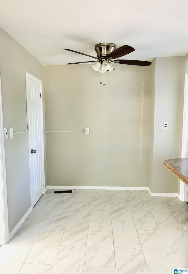 16 9th Ter, Birmingham, AL 35211 - spare room featuring light marble finish flooring, a ceiling fan, and baseboards