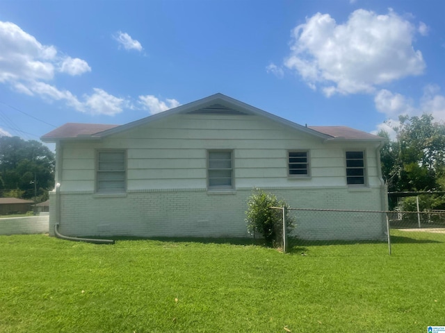 view of home's exterior with a lawn