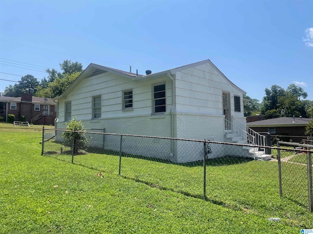 view of side of property with a lawn