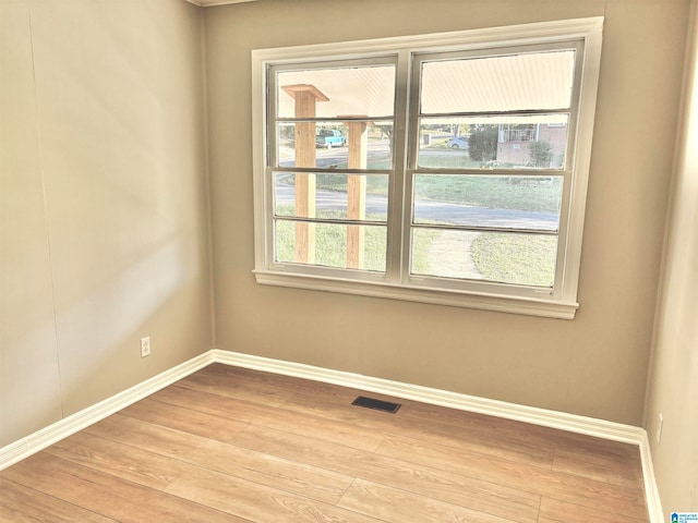 spare room featuring light hardwood / wood-style floors