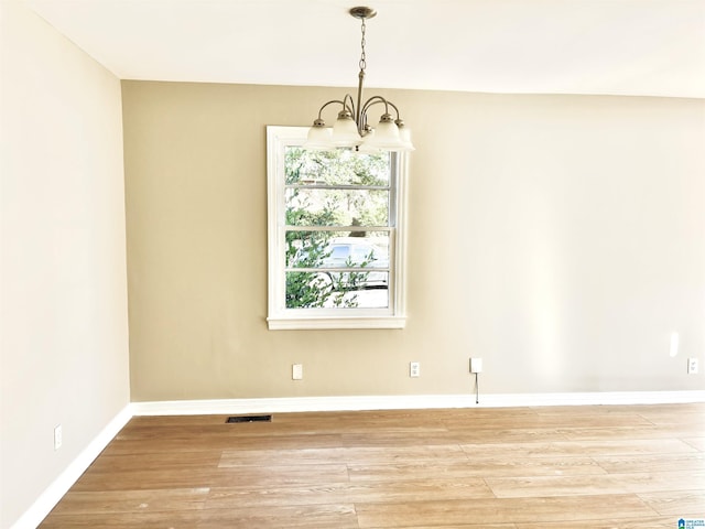 16 9th Ter, Birmingham, AL 35211 - empty room with a chandelier, light wood-style flooring, and baseboards