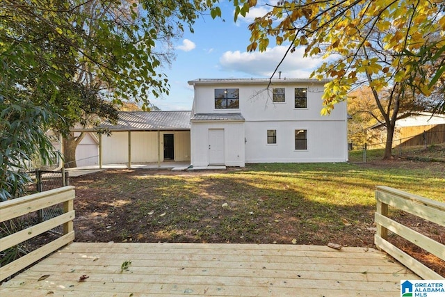 back of property featuring a yard and a garage