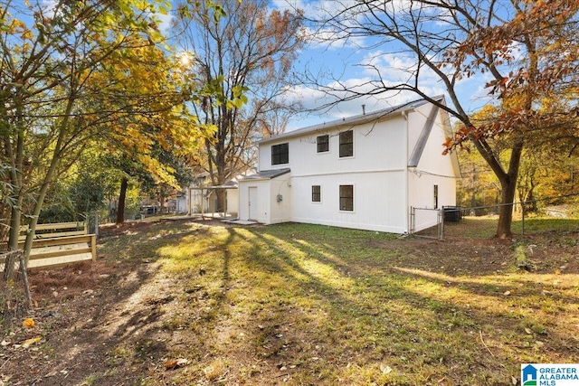 rear view of house with a yard