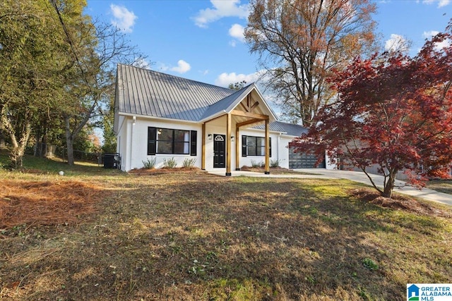 modern farmhouse with a garage and a front lawn