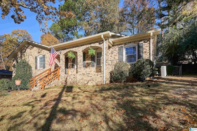 ranch-style house with a porch and a front yard