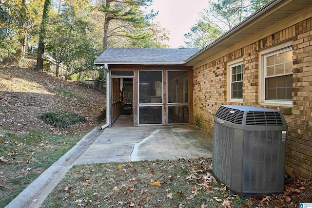 view of patio featuring central AC and a sunroom