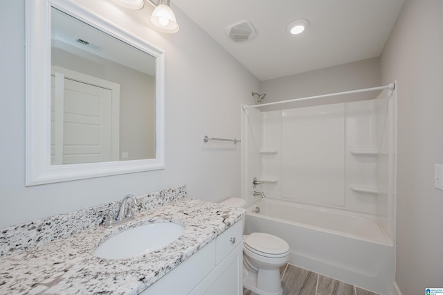 full bathroom featuring shower / tub combination, vanity, wood-type flooring, and toilet