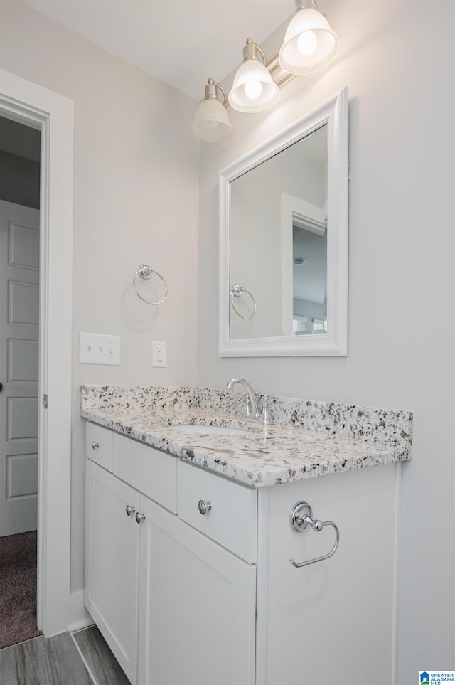 bathroom featuring hardwood / wood-style floors and vanity