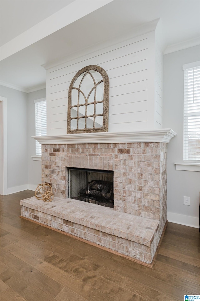 interior details with a fireplace, hardwood / wood-style flooring, and crown molding