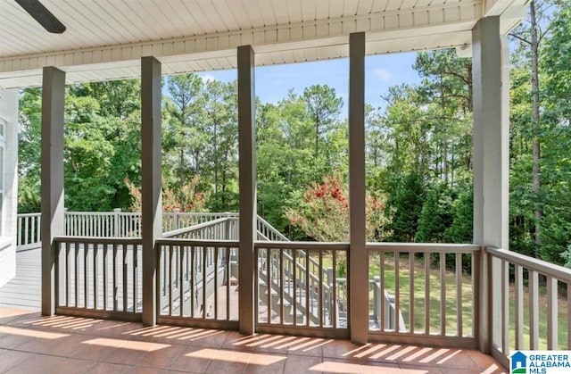 unfurnished sunroom with ceiling fan and wooden ceiling