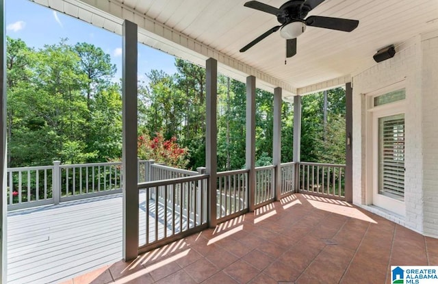 unfurnished sunroom with ceiling fan and wooden ceiling