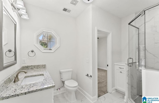 bathroom featuring vanity, toilet, and a shower with door