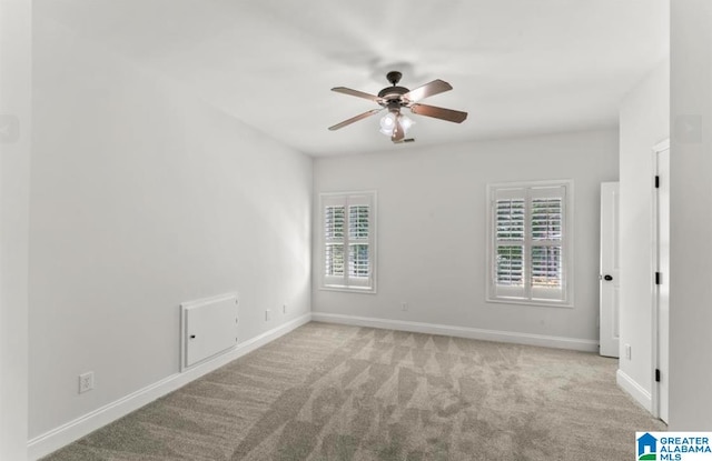 unfurnished room with light colored carpet and ceiling fan