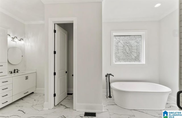 bathroom with a bathtub, ornamental molding, and vanity