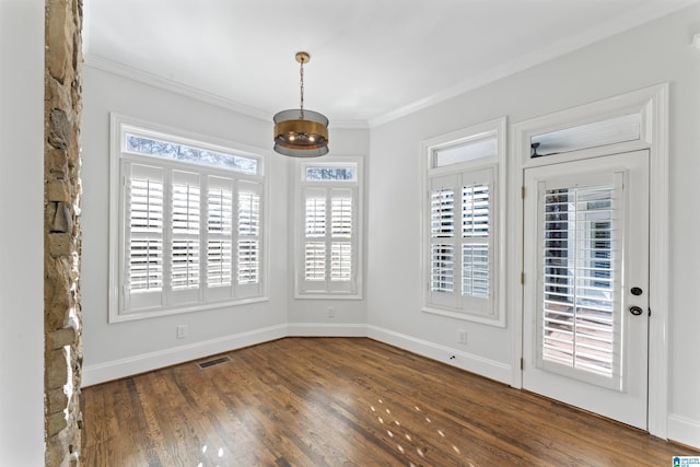 interior space with crown molding, dark wood-type flooring, and a wealth of natural light