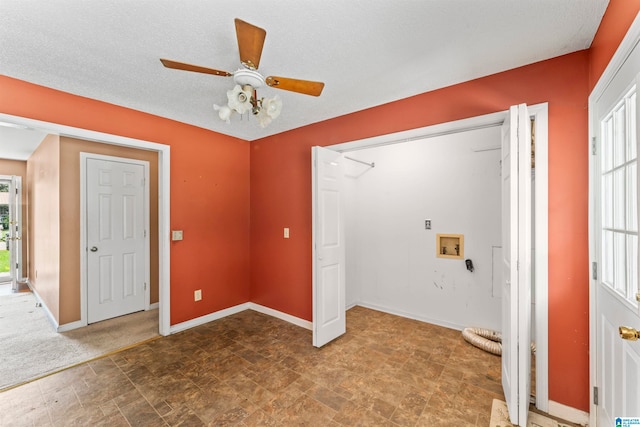 interior space with washer hookup, a textured ceiling, plenty of natural light, and ceiling fan