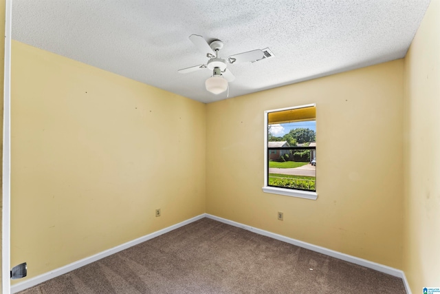 carpeted empty room featuring ceiling fan and a textured ceiling