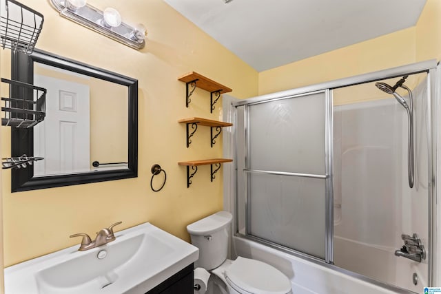 full bathroom featuring vanity, toilet, and enclosed tub / shower combo