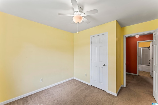 unfurnished bedroom with ceiling fan and carpet floors