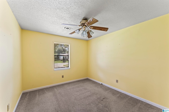 unfurnished room with ceiling fan, carpet floors, and a textured ceiling