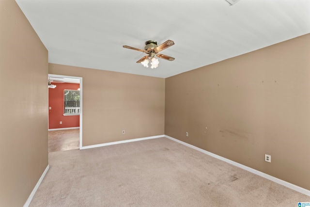 unfurnished room featuring light carpet and ceiling fan