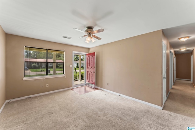 spare room with light carpet and ceiling fan