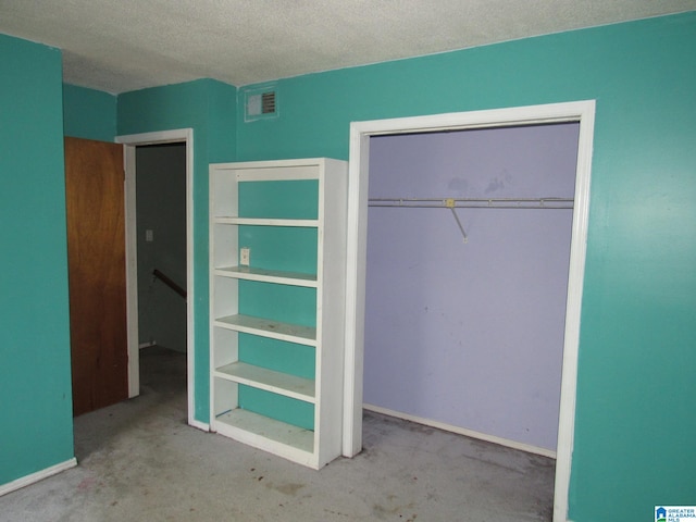 unfurnished bedroom featuring a closet, light colored carpet, and a textured ceiling