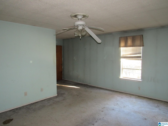 carpeted spare room featuring a textured ceiling