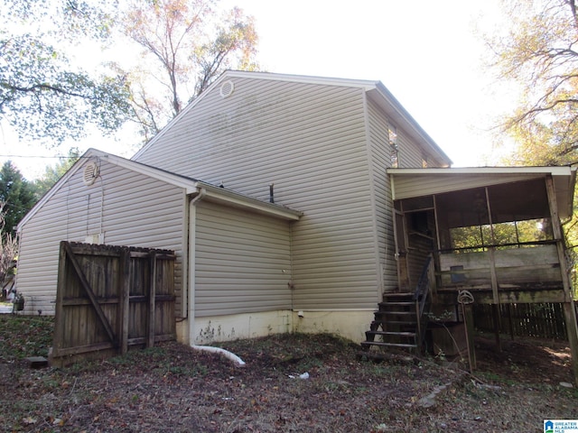 view of home's exterior with a sunroom