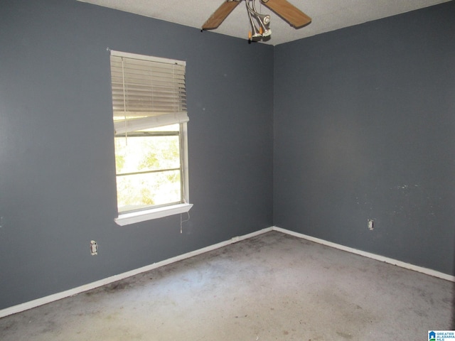 carpeted empty room featuring a textured ceiling